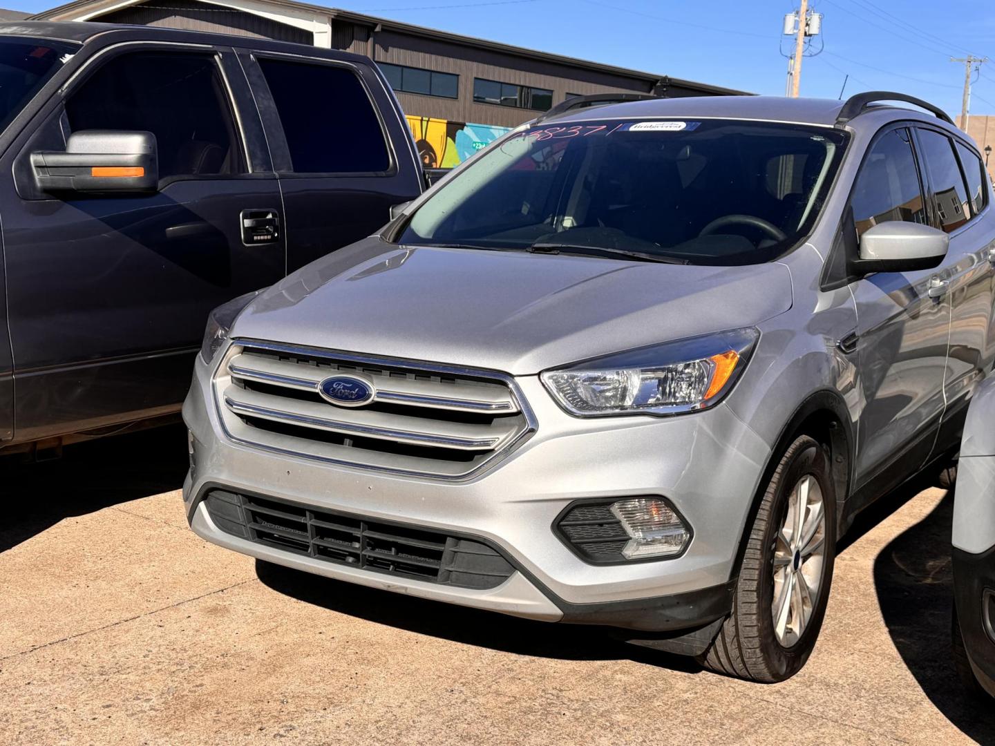 2018 SILVER Ford Escape SE 4WD (1FMCU9GD0JU) with an 1.5L L4 DOHC 16V engine, 6A transmission, located at 8101 E. Skelly Dr., Tulsa, OK, 74129, (918) 592-3593, 36.121891, -95.888802 - Photo#0